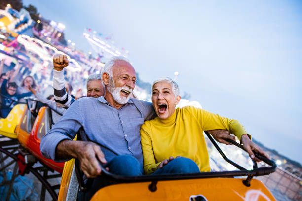 Retired couple having fun on a carnival ride